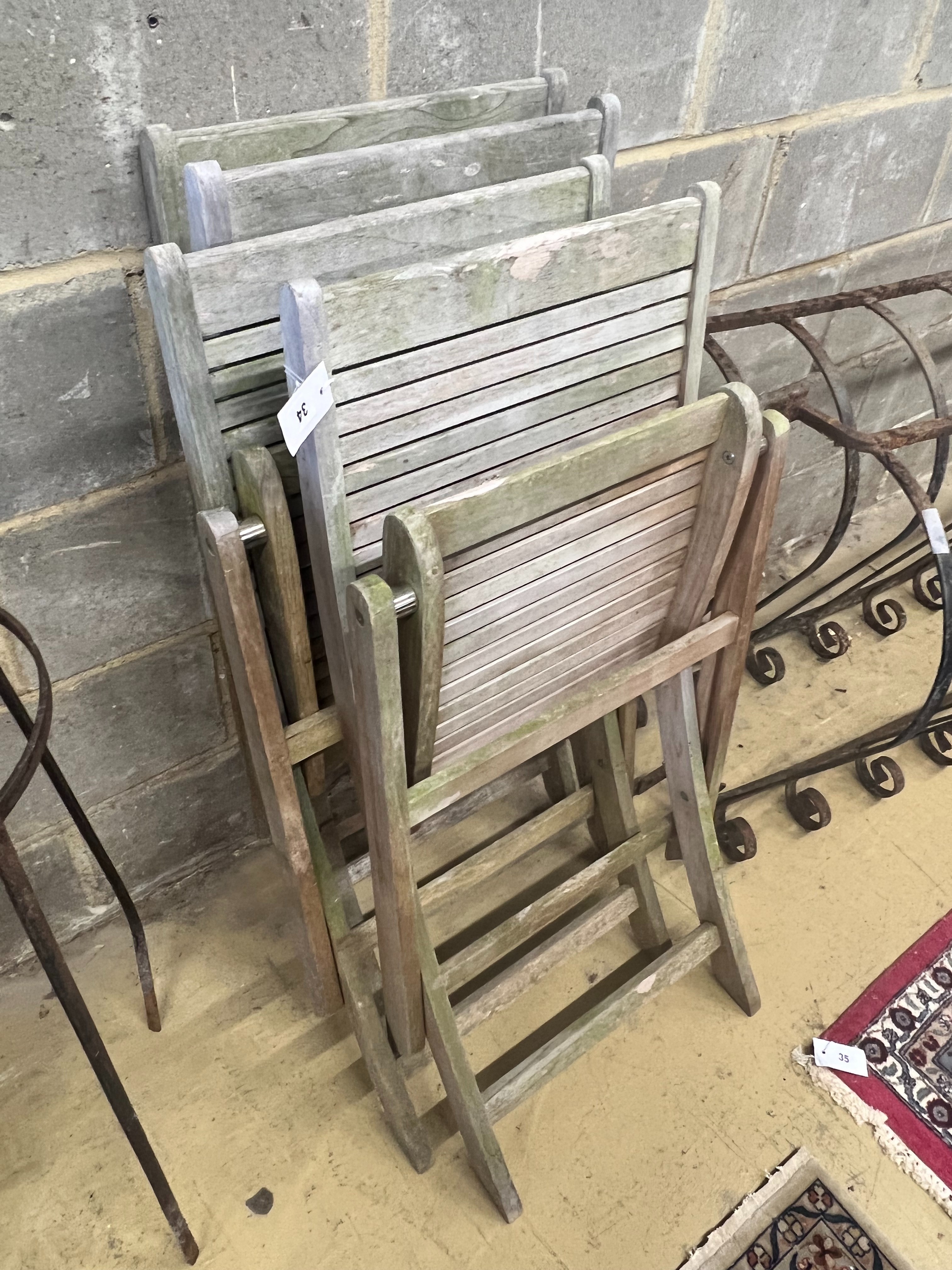 A set of four teak folding garden chairs
